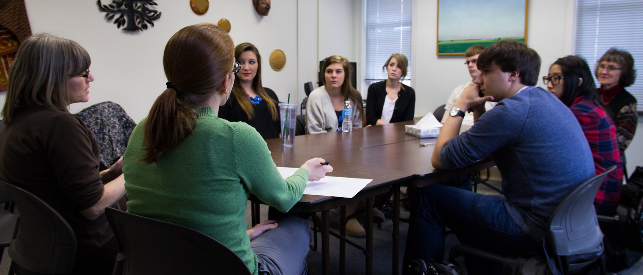 students and counselors sitting around conference table